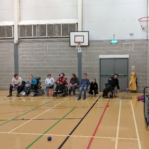a group of 8 enjoying a game of boccia